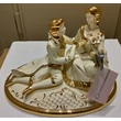 Oval ceramic bonbonier with couple. Color: cream color, gold