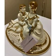 Oval ceramic bonbonier with couple. Color: cream color, gold