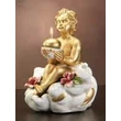 Ceramic angel playing on a cloud with candle-holder.