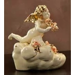 Ceramic angel playing on a cloud.