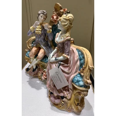 Ceramic sitting couple. Color: gold