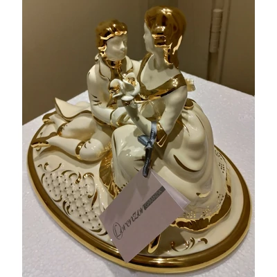 Oval ceramic bonbonier with couple. Color: cream color, gold