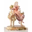 Ceramic lady sitting on piano. Color: gold